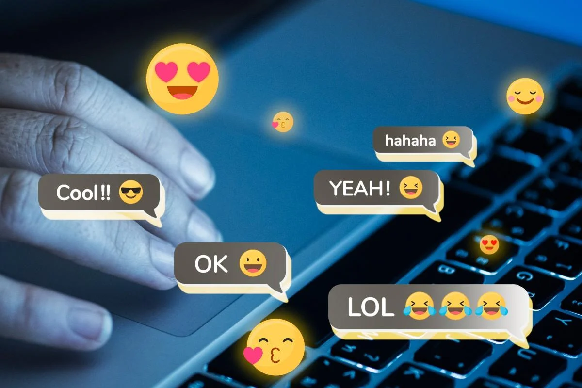 Hand using a laptop with floating emojis and chat bubbles showing common reactions — Most Used English Phrases with Explanations.